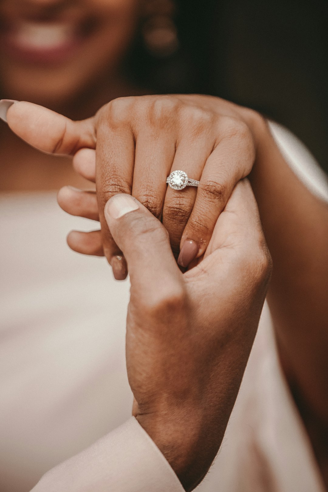 Engagement ring proposal holding hands